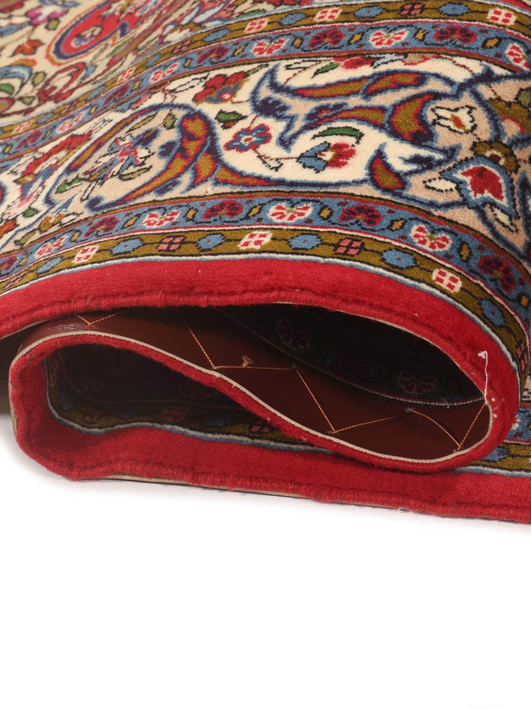 A hand-knotted Sarough rug from the Middle East featuring a vibrant red field with intricate floral patterns.