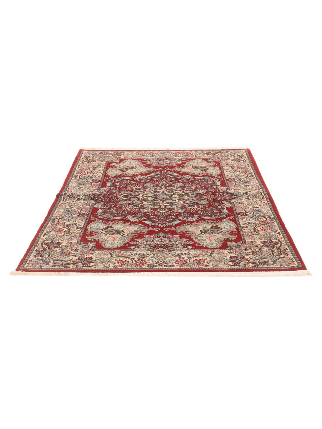 A hand-knotted Sarough rug from the Middle East featuring a red field with floral patterns.