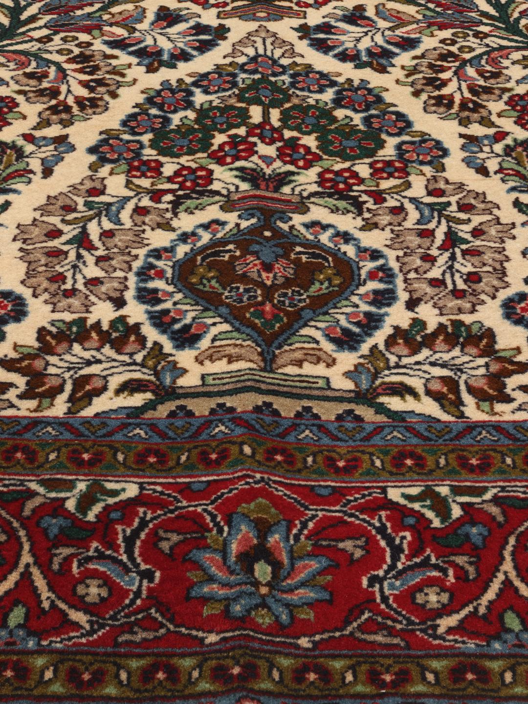 Hand-knotted Sarough rug from the Middle East with a floral pattern in red and beige.