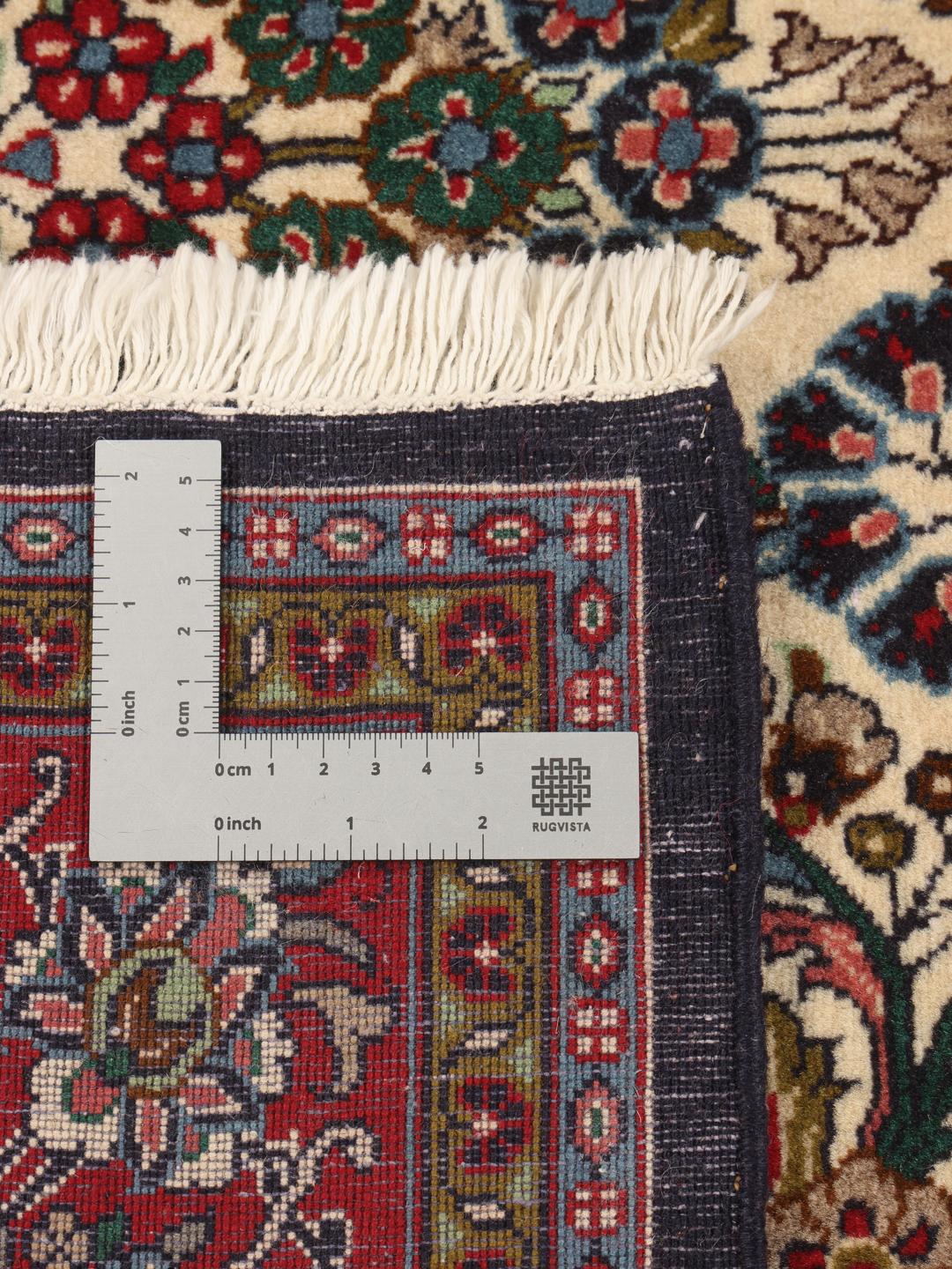 Hand-knotted Sarough rug from the Middle East with a floral pattern in red and beige.