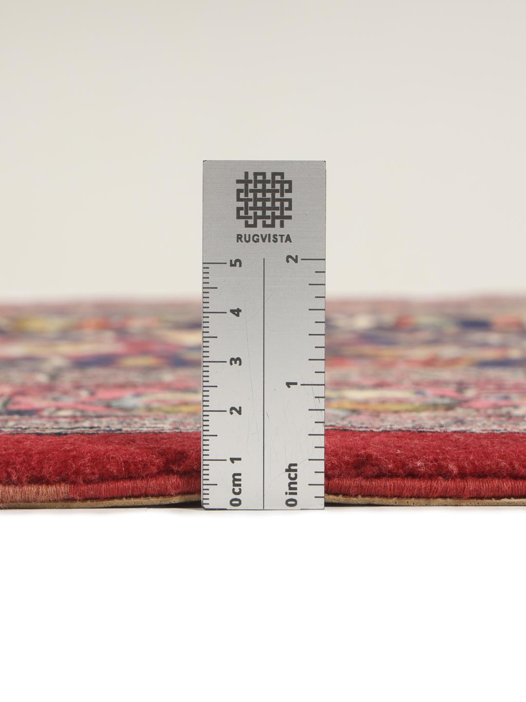 A hand-knotted Sarouk rug from the Middle East featuring a dark-blue field with colourful floral motifs