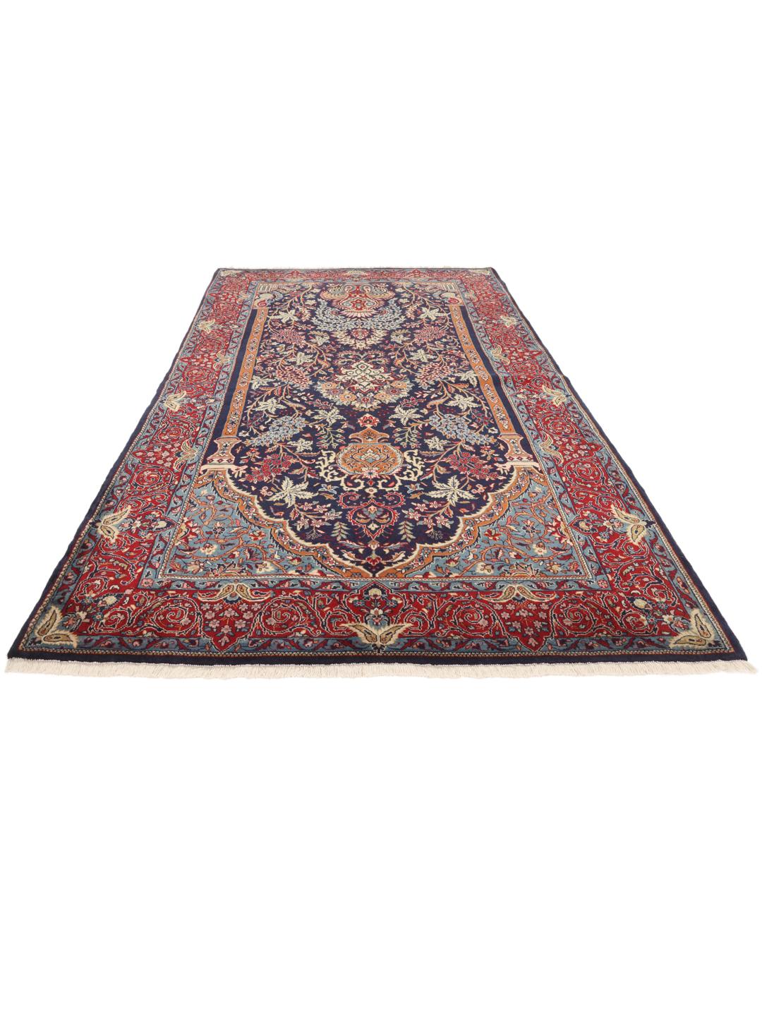 Hand-knotted Sarough rug featuring a traditional floral mihrab design in deep blue and red tones.