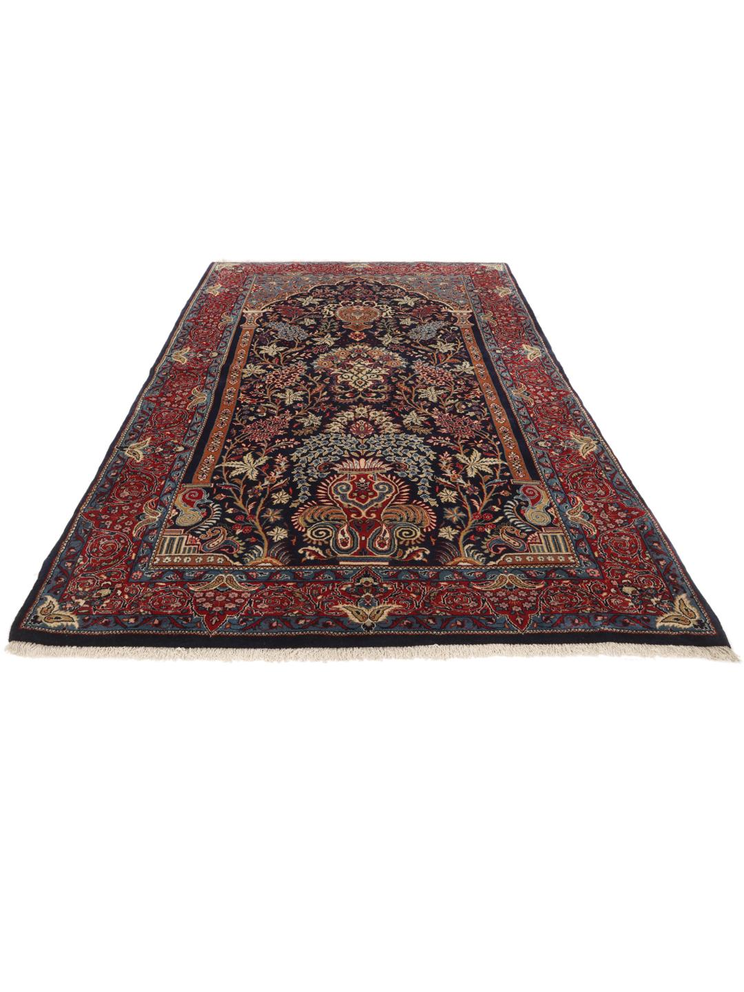 Hand-knotted Sarough rug featuring a traditional floral mihrab design in deep blue and red tones.