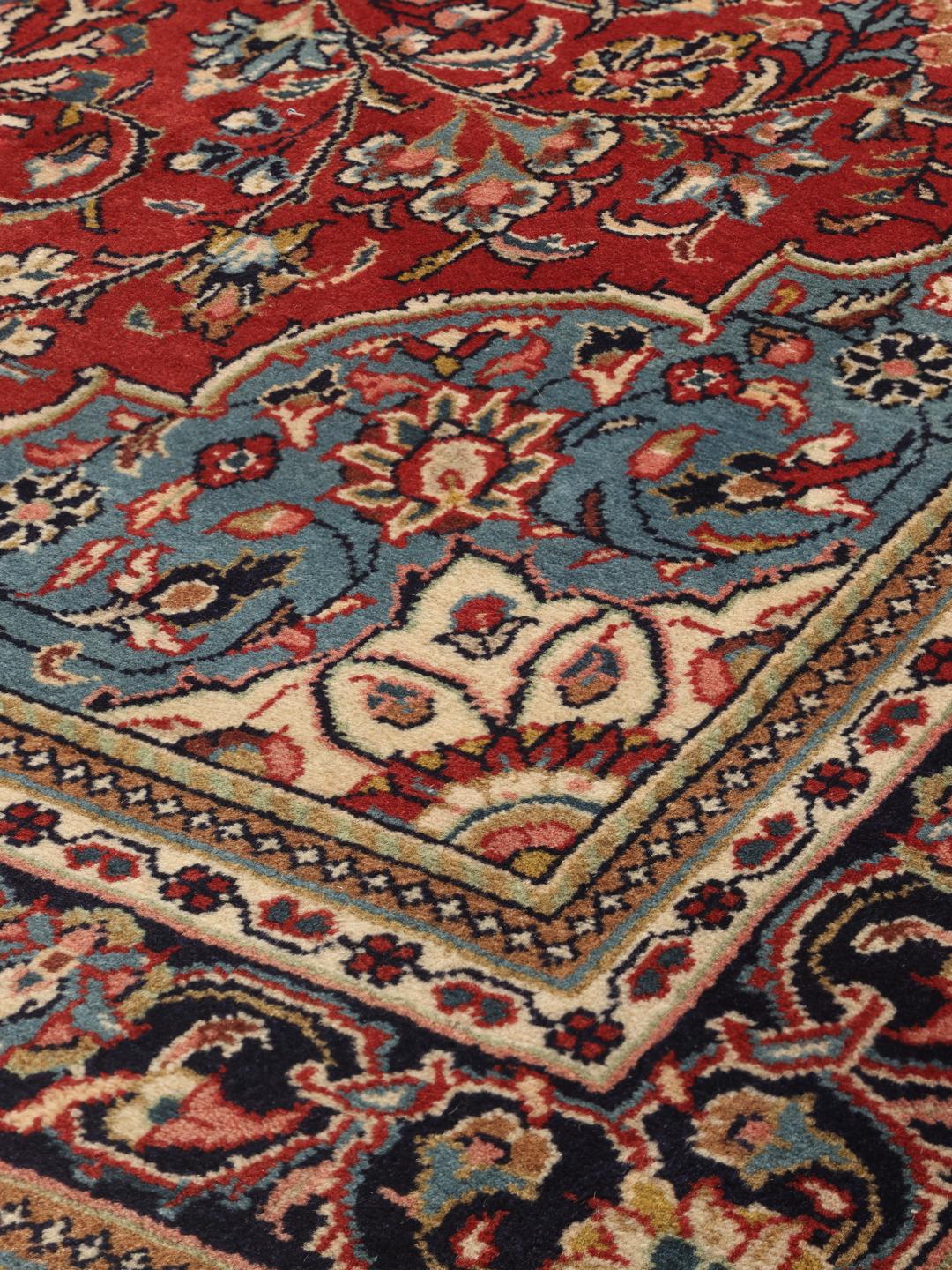Hand-knotted Sarough rug from the Middle East with a red and blue floral pattern.