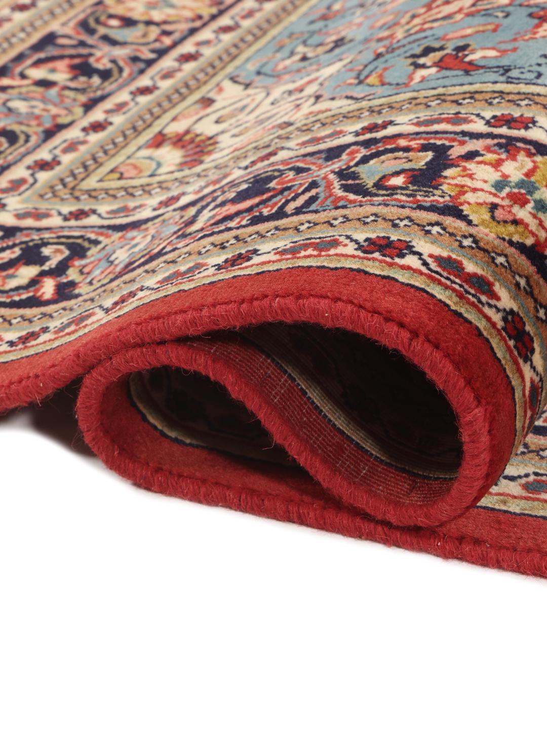 Hand-knotted Sarough rug from the Middle East with a red and blue floral pattern.