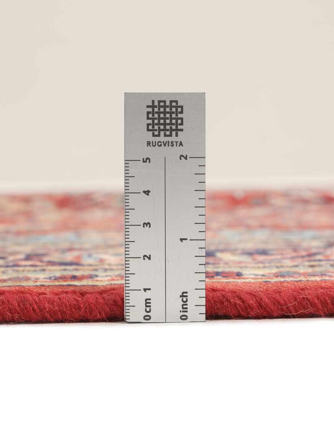 Hand-knotted Sarough rug from the Middle East with a red and blue floral pattern.