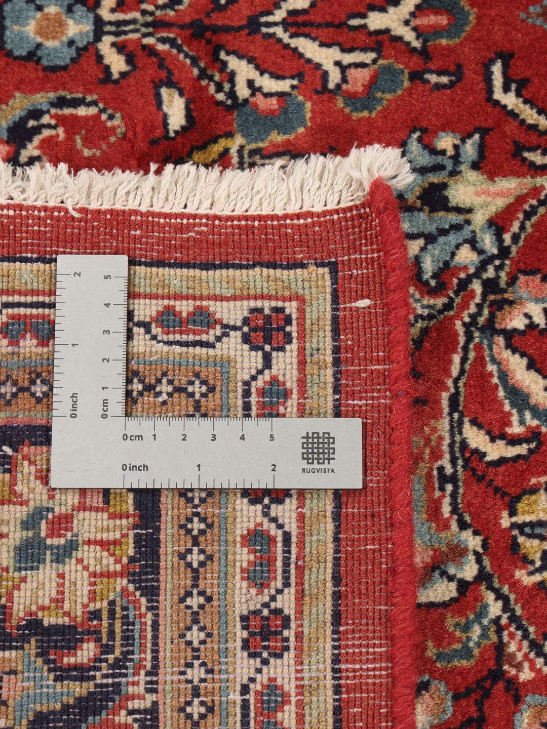 Hand-knotted Sarough rug from the Middle East with a red and blue floral pattern.