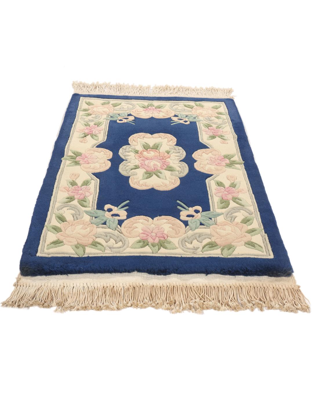 Hand-knotted Chinese rug with floral motifs on a deep blue field