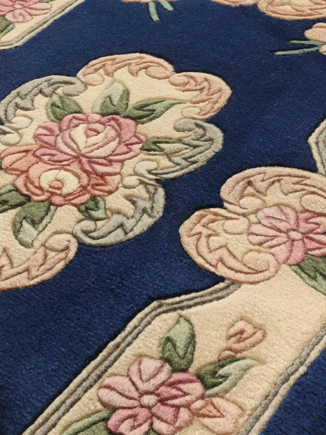 Hand-knotted Chinese rug with floral motifs on a deep blue field