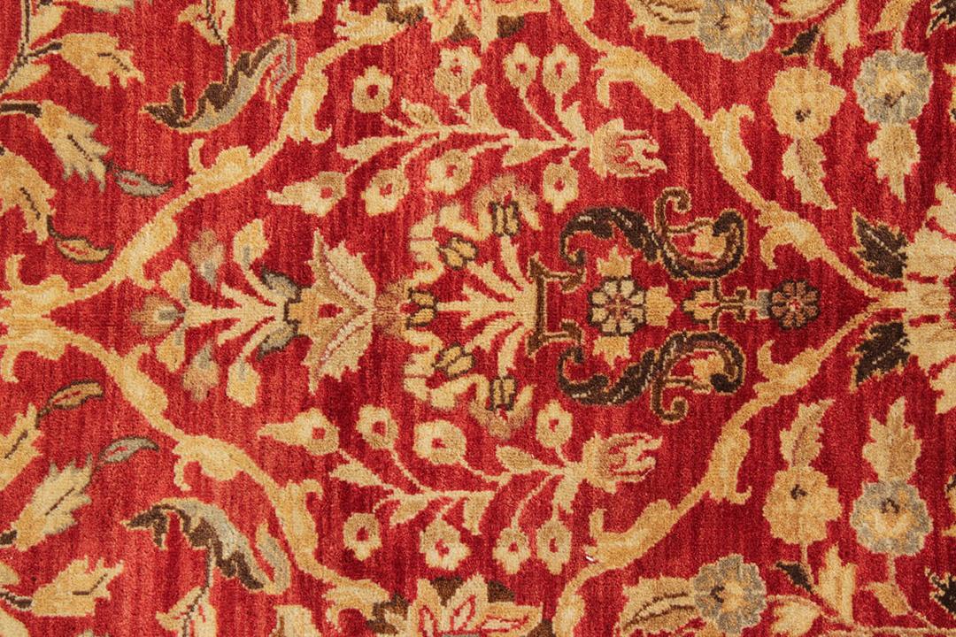 Handgeknoopt Indiaas tapijt met een rijk rood bloemenpatroon.