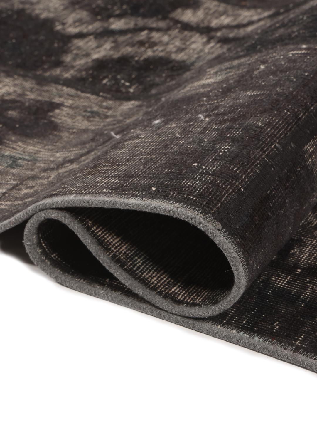 A unique patchwork rug with black and grey tones from the Middle East