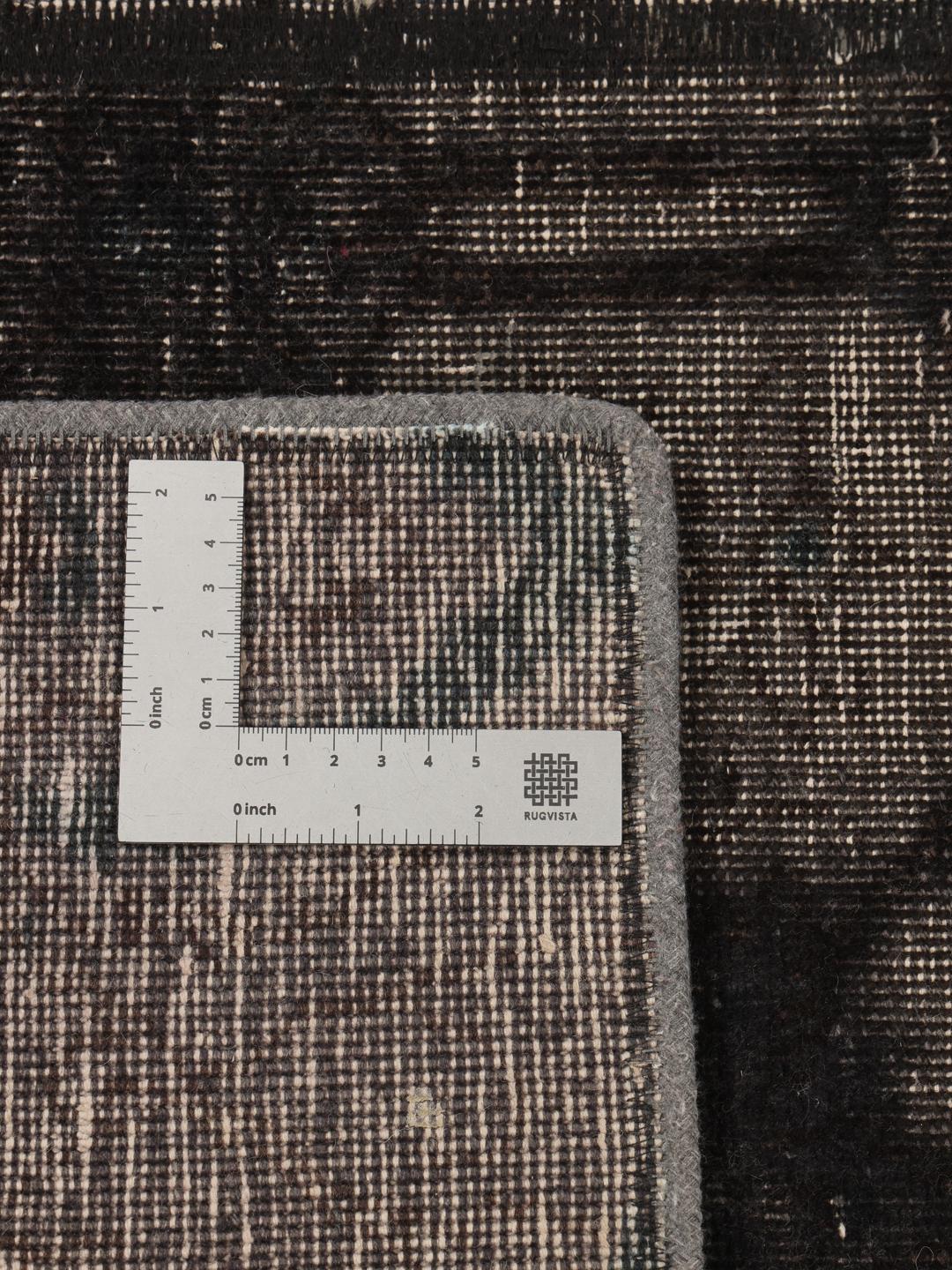 A unique patchwork rug with black and grey tones from the Middle East