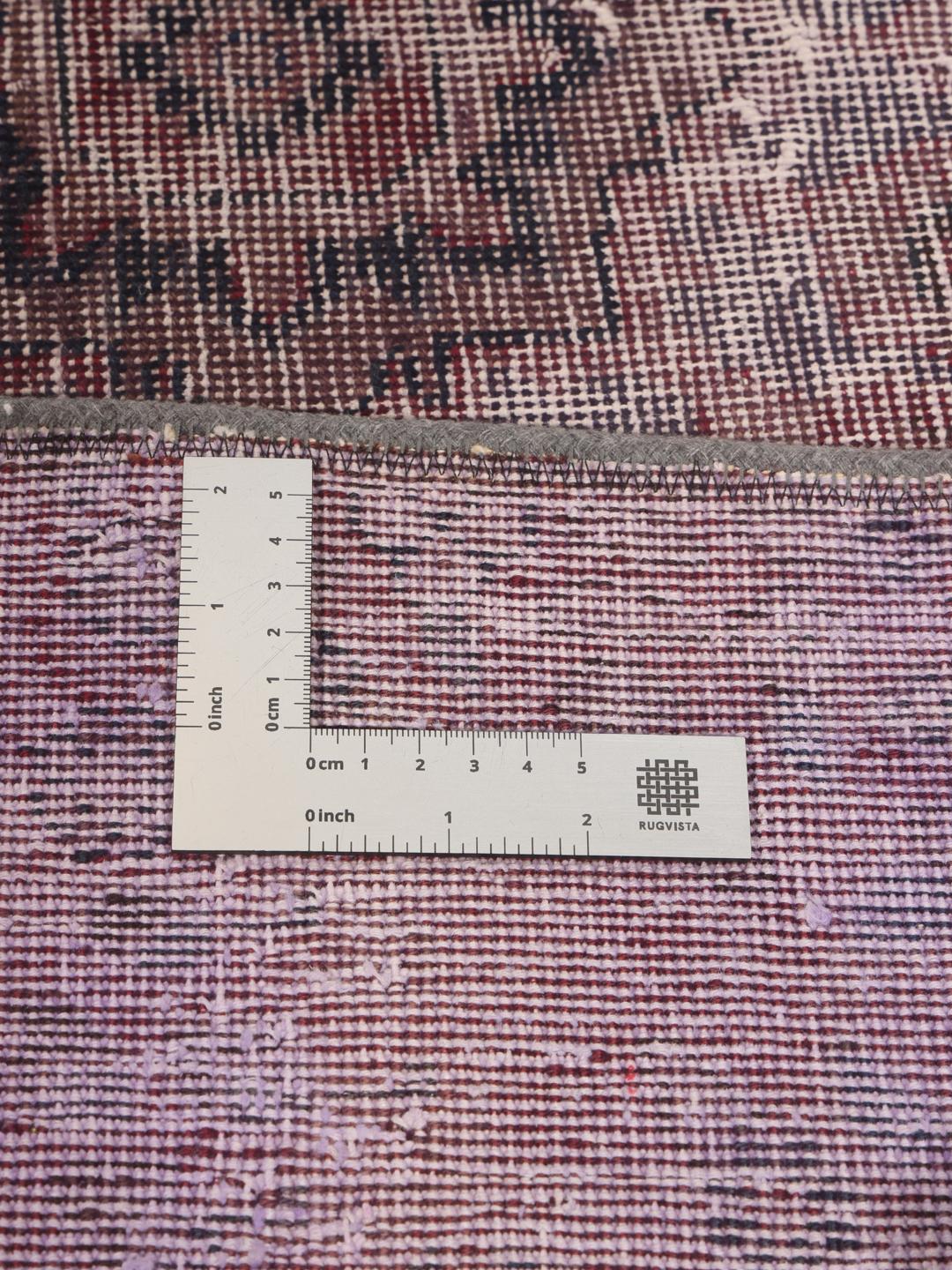 A unique patchwork rug with deep red and dark tones, Middle Eastern origin