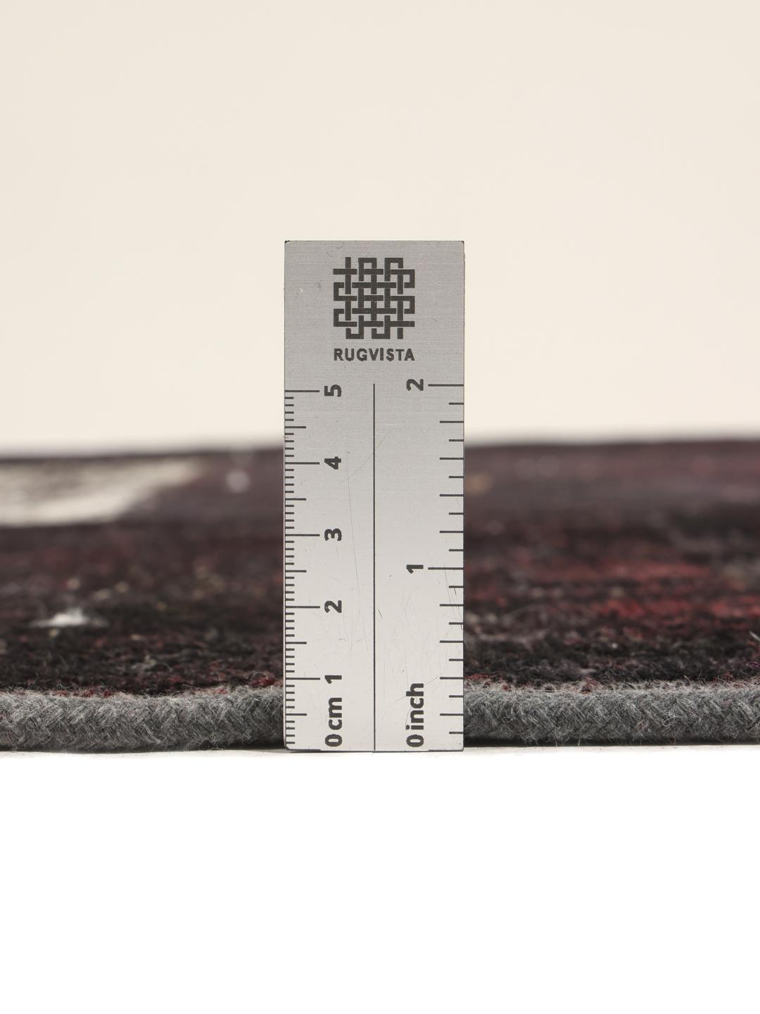 A rectangular patchwork rug from the Middle East featuring a black and grey colour palette.