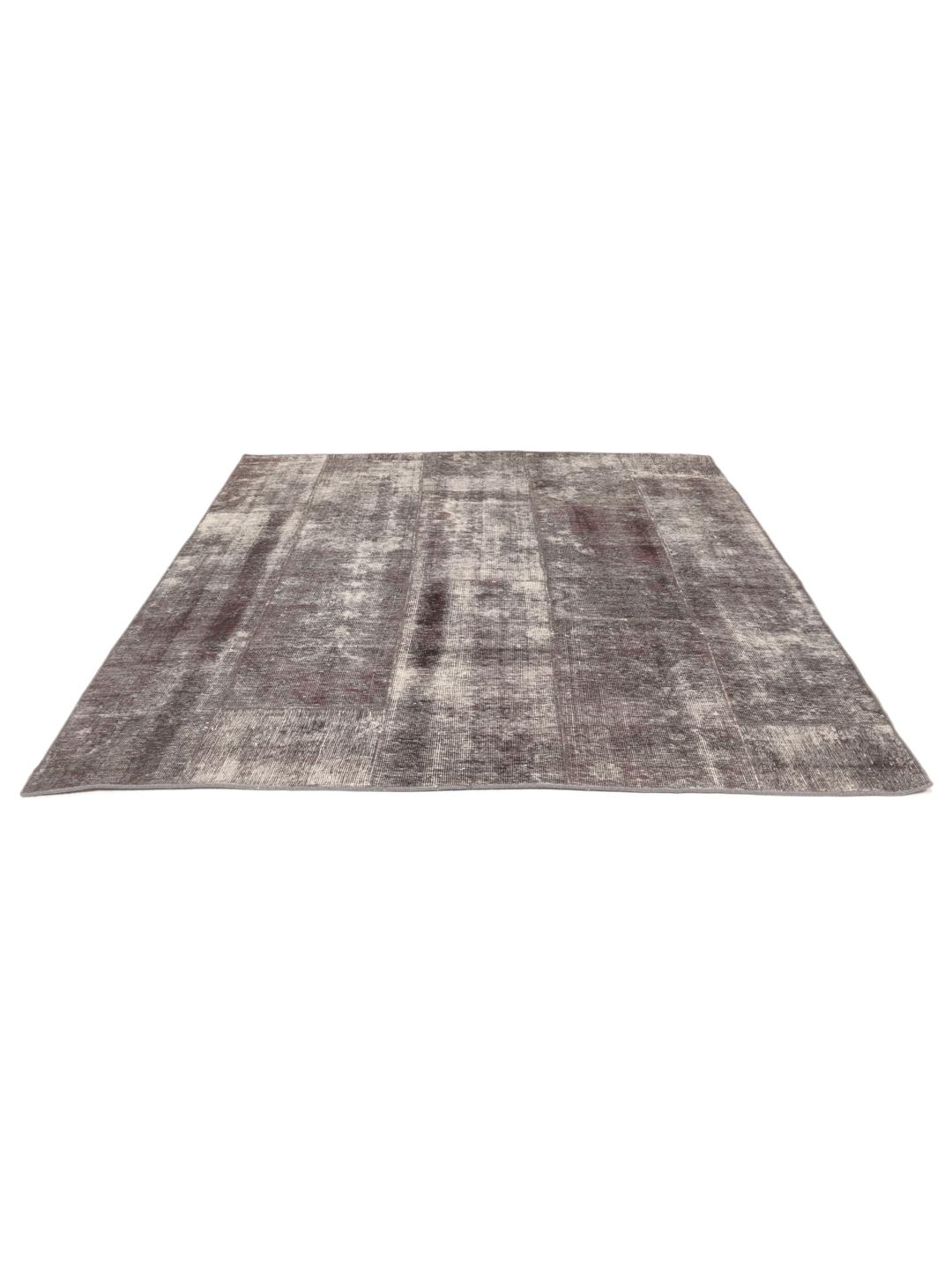 A unique, hand-knotted patchwork rug from the Middle East in dark-grey tones.