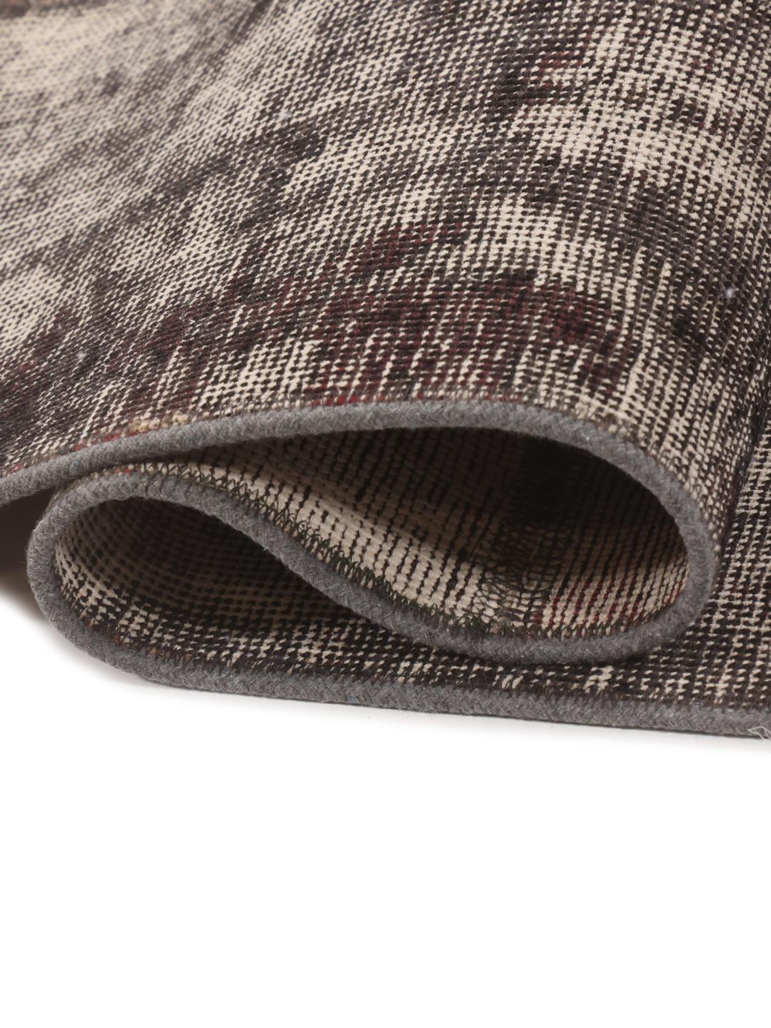 A unique, hand-knotted patchwork rug from the Middle East in dark-grey tones.