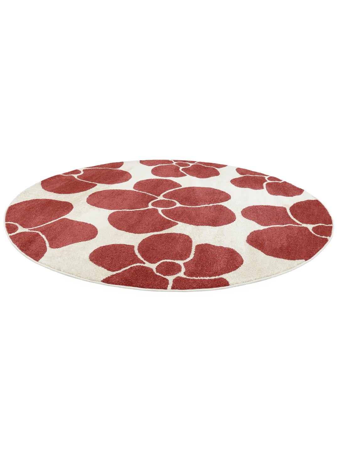 Rond vloerkleed met een donkerrood en gebroken wit bloemenpatroon