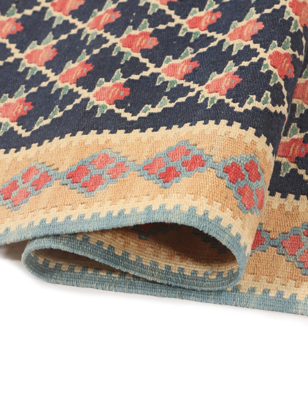 A hand-woven Kelim Senneh Fine rug from the Middle East in dark-blue and beige tones.