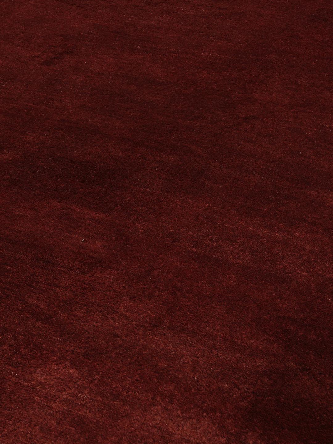 A deep dark-red hand-knotted Gabbeh Fine rug from the Middle East.