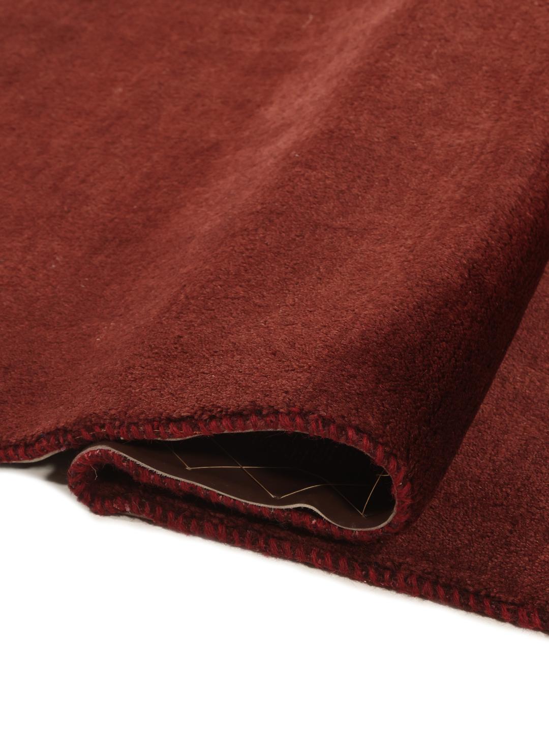 A deep dark-red hand-knotted Gabbeh Fine rug from the Middle East.