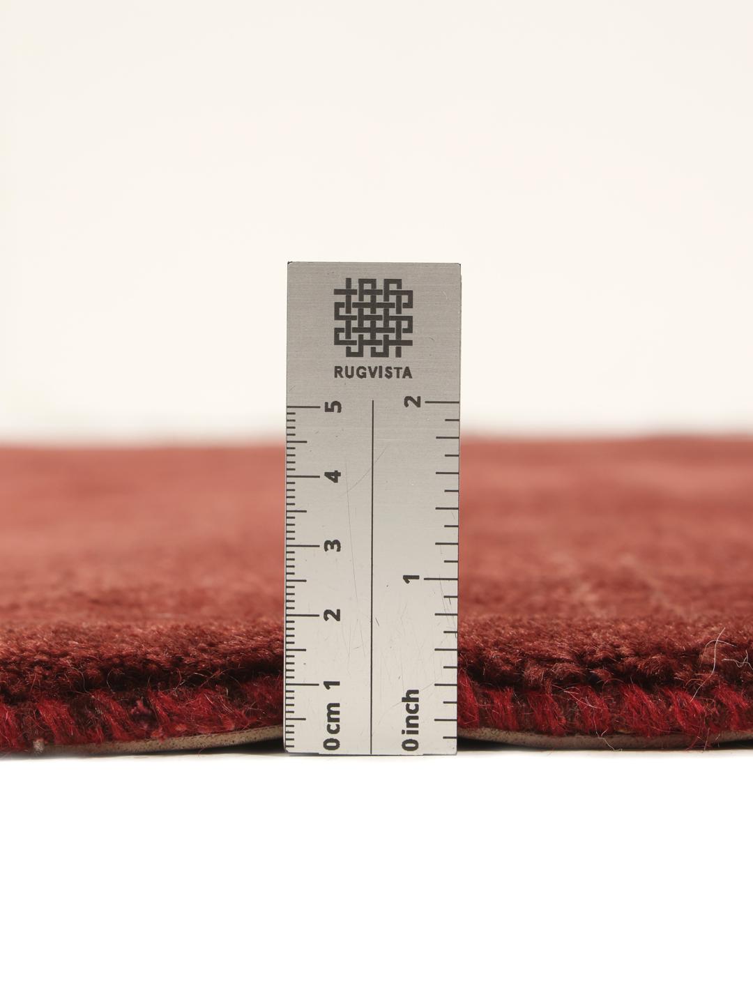 A deep dark-red hand-knotted Gabbeh Fine rug from the Middle East.