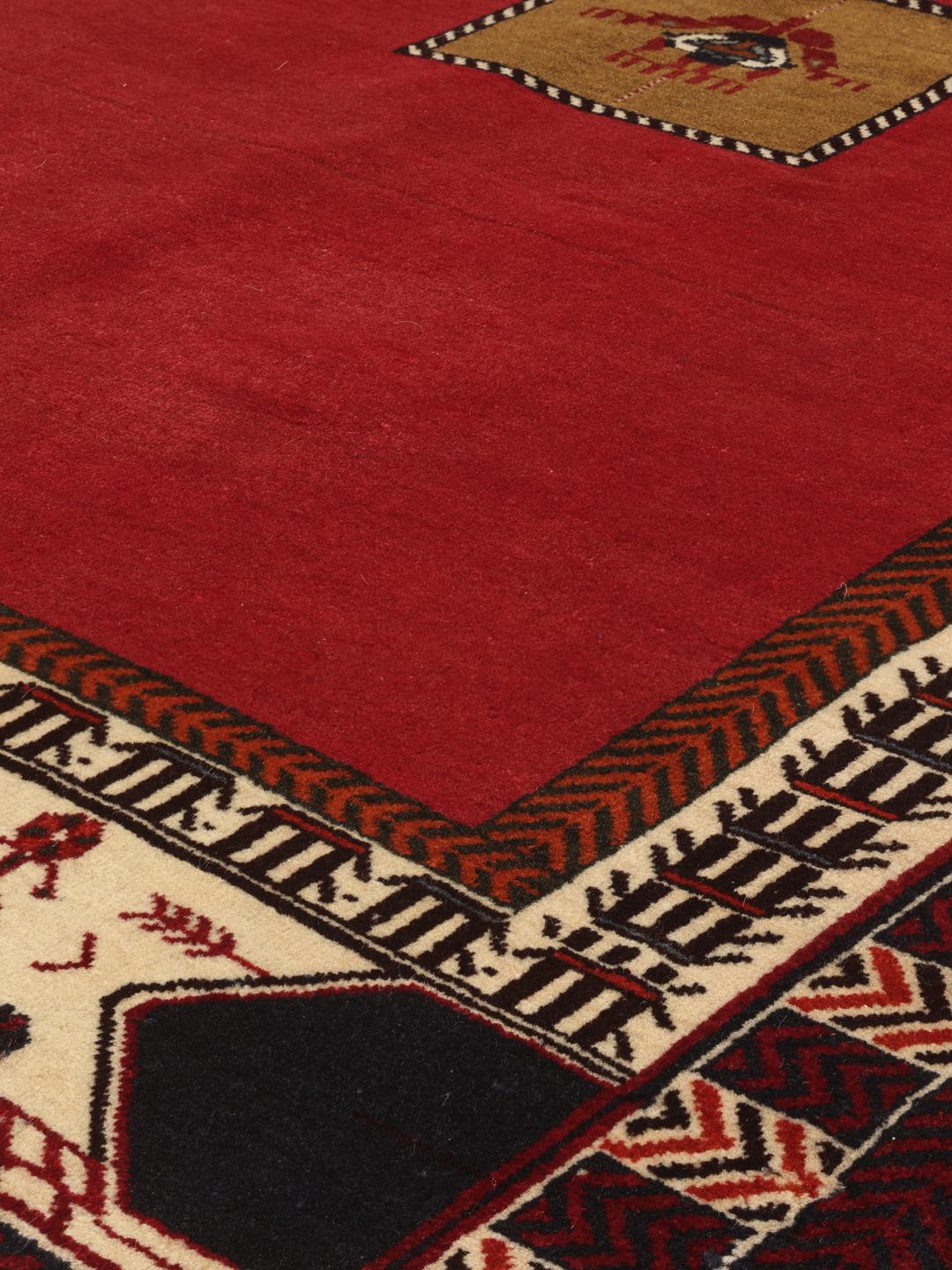 Hand-knotted Qashqai rug from the Middle East in vibrant red with geometric motifs