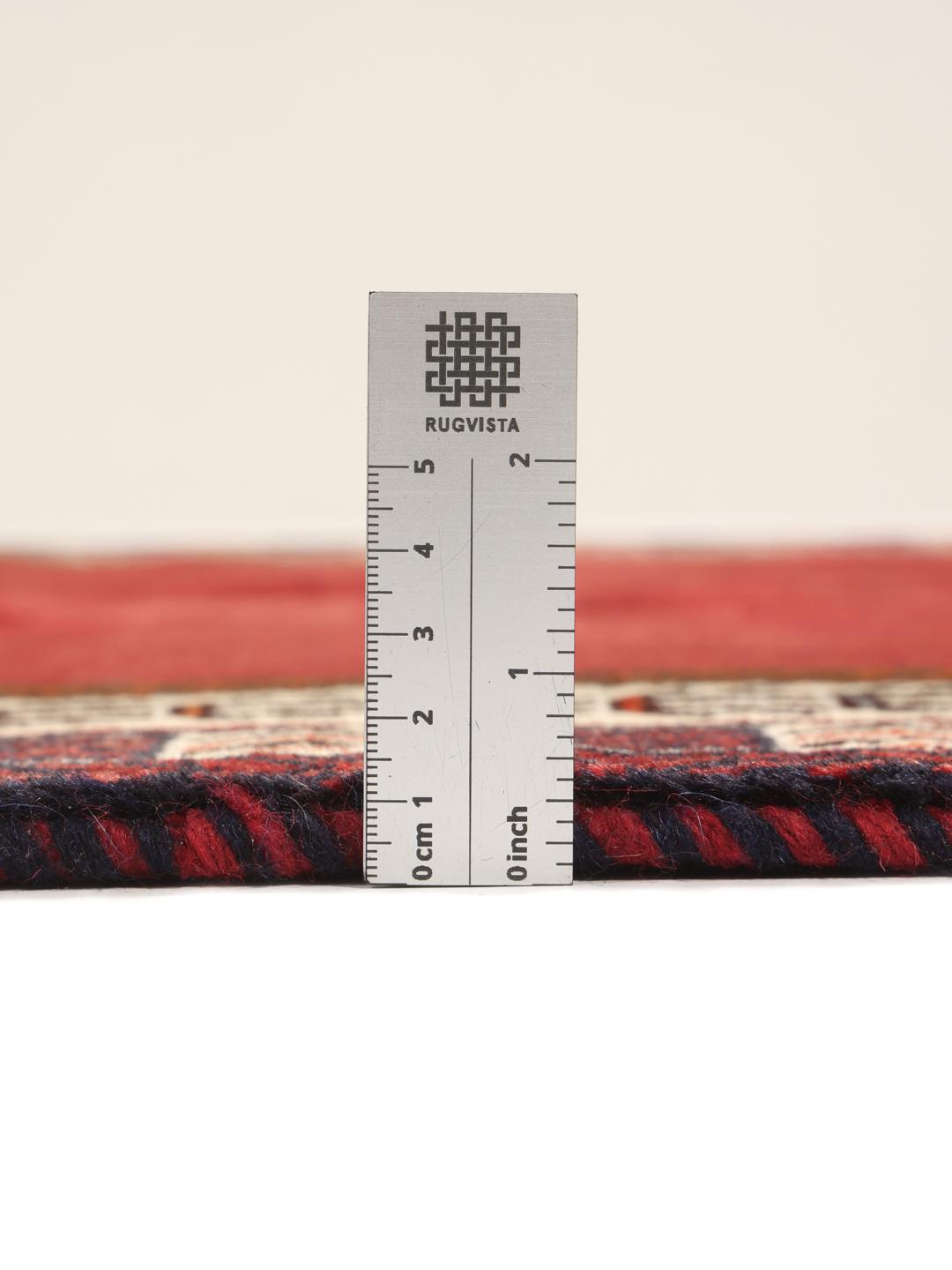 Hand-knotted Qashqai rug from the Middle East in vibrant red with geometric motifs