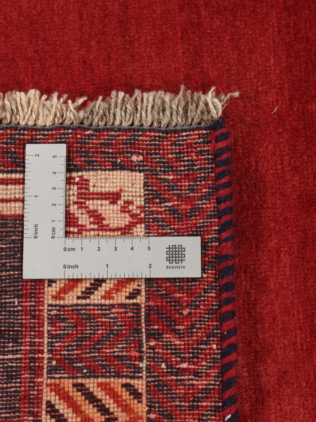 Hand-knotted Qashqai rug from the Middle East in vibrant red with geometric motifs