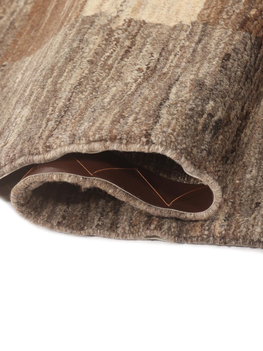 Hand-knotted Gabbeh Fine rug from the Middle East in shades of brown and beige.