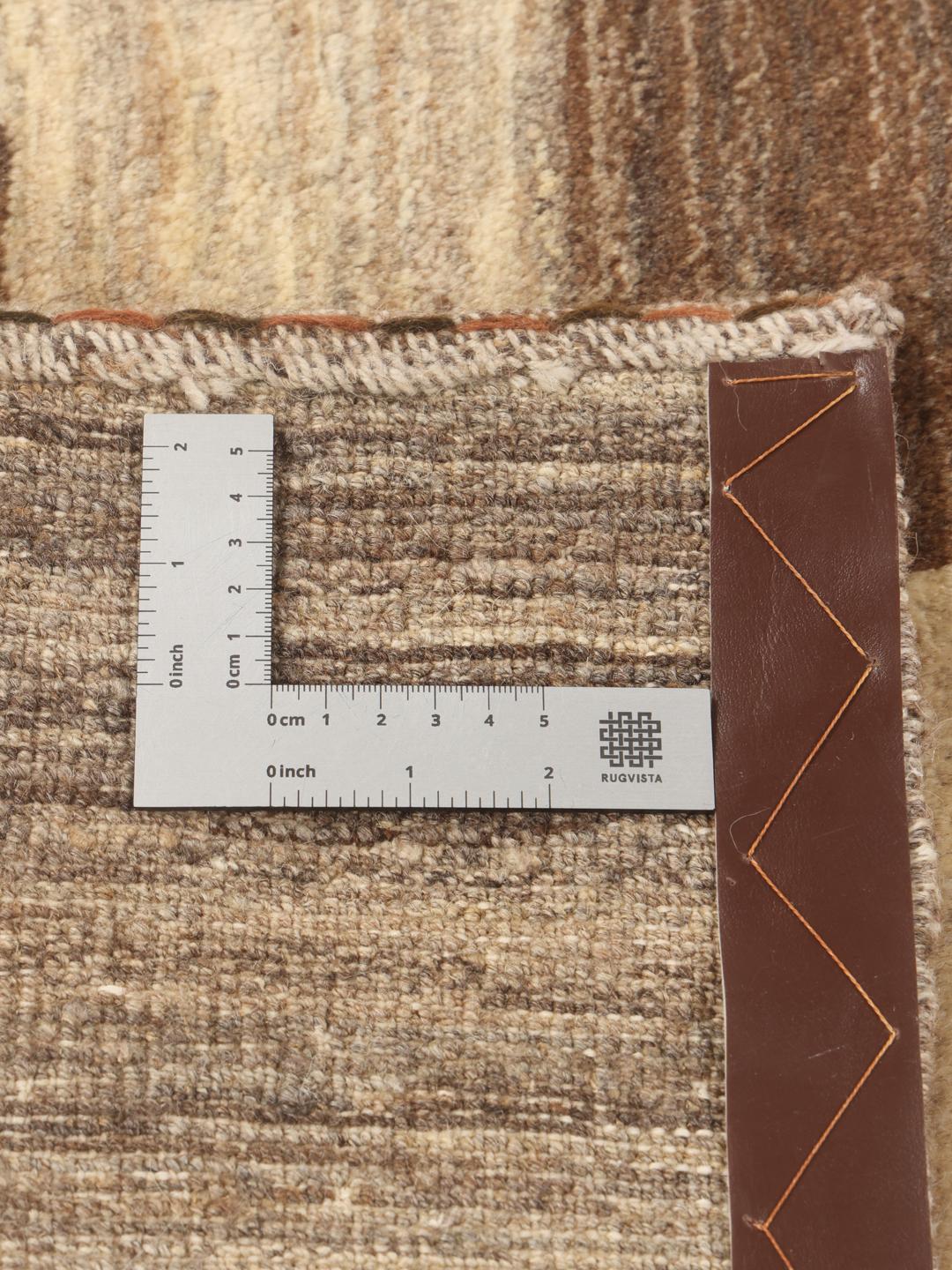 Hand-knotted Gabbeh Fine rug from the Middle East in shades of brown and beige.