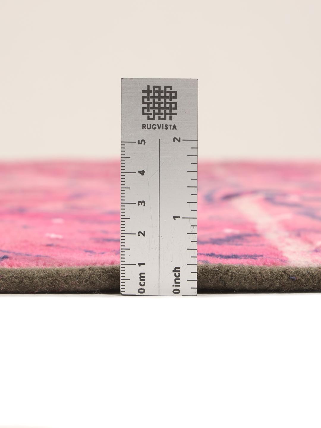 A vibrant dark-pink patchwork rug with Middle Eastern inspired motifs