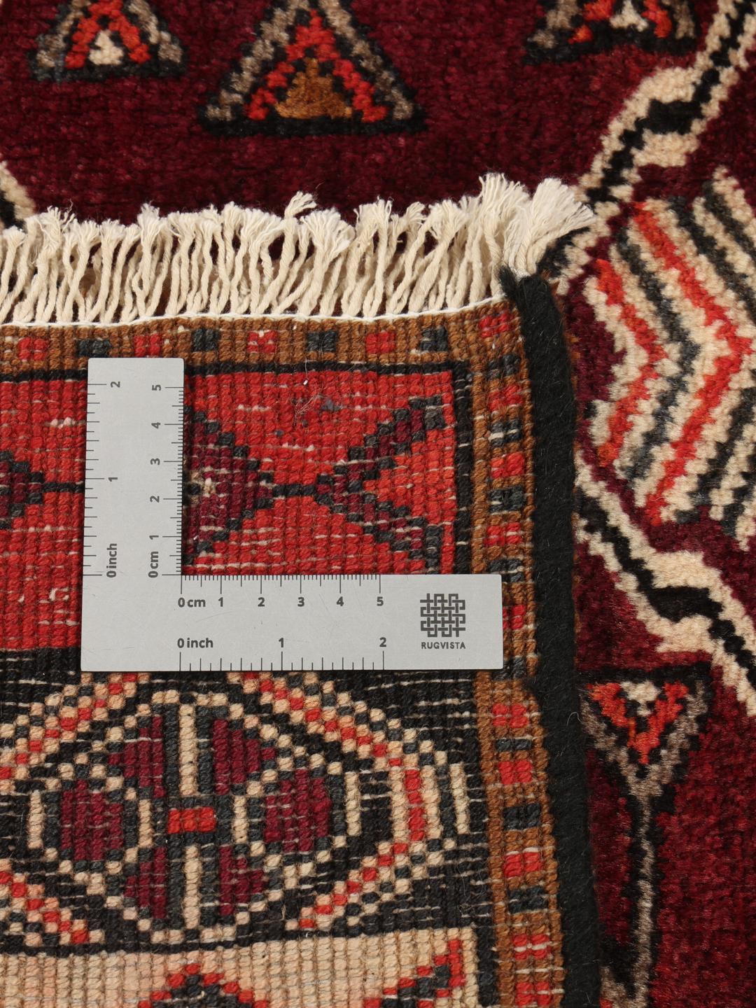 Håndknyttet Lori-tæppe med mørkerøde og sorte geometriske stammemønstre fra Mellemøsten.