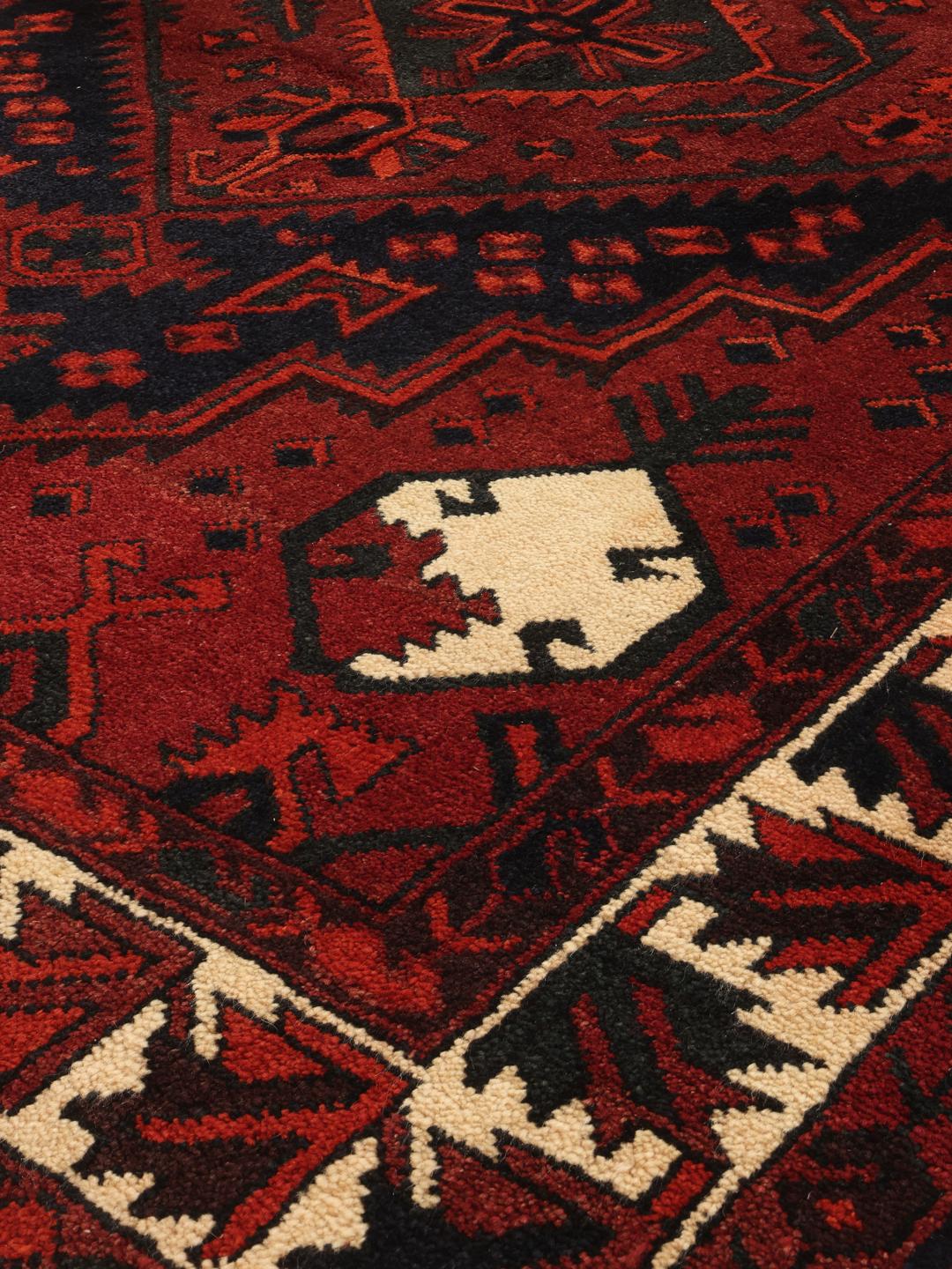 Hand-knotted Lori rug from the Middle East in dark red and black tones