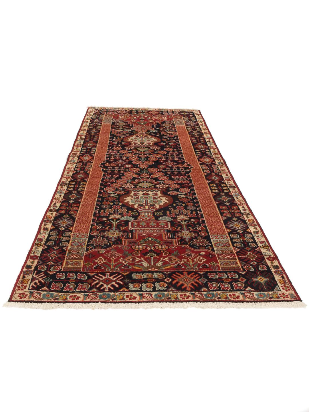 A hand-knotted Qashqai runner featuring traditional tribal motifs in deep red and navy blue.
