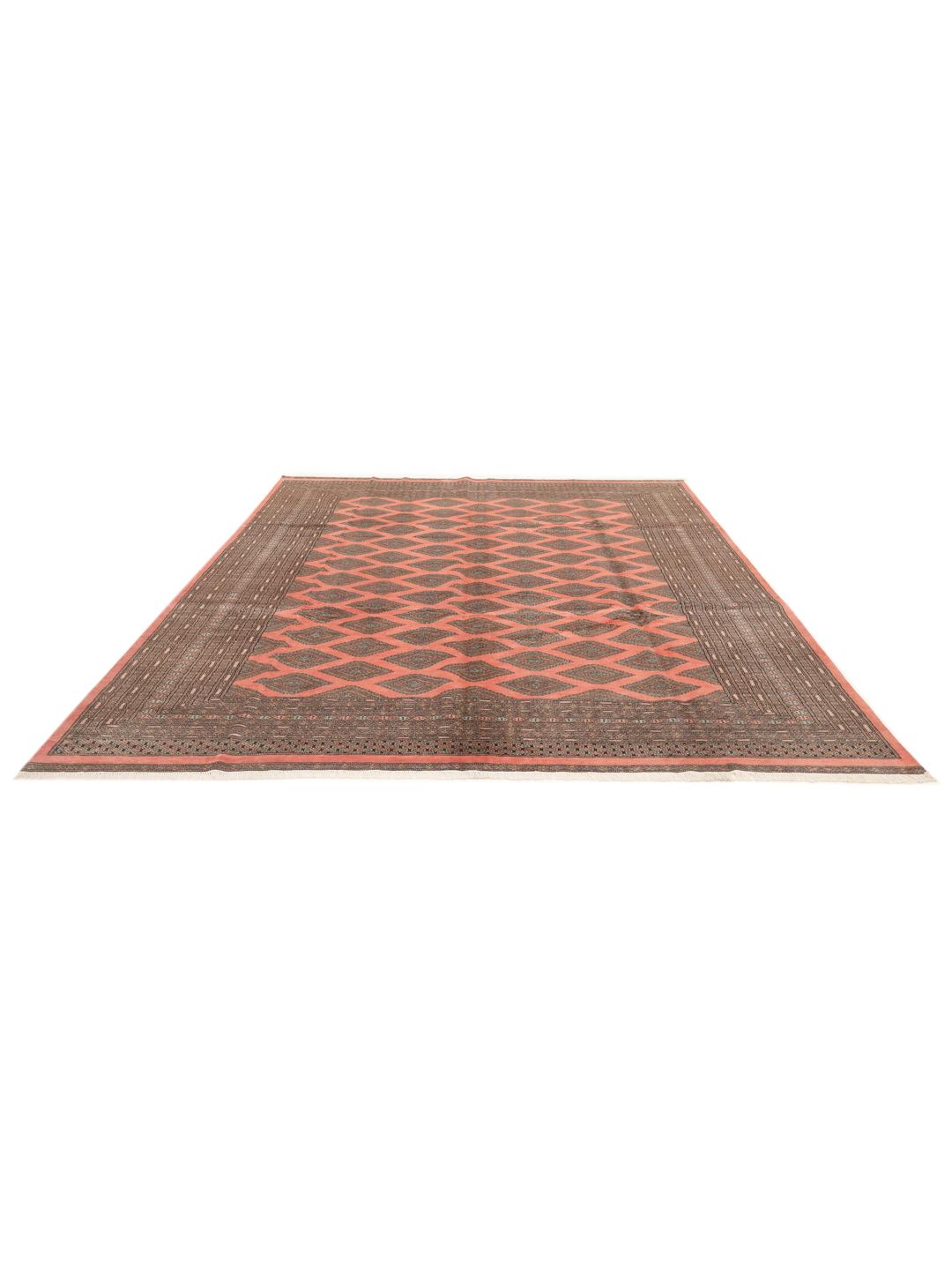 A large hand-knotted Pakistan Bokhara 2ply rug in pink with geometric patterns.