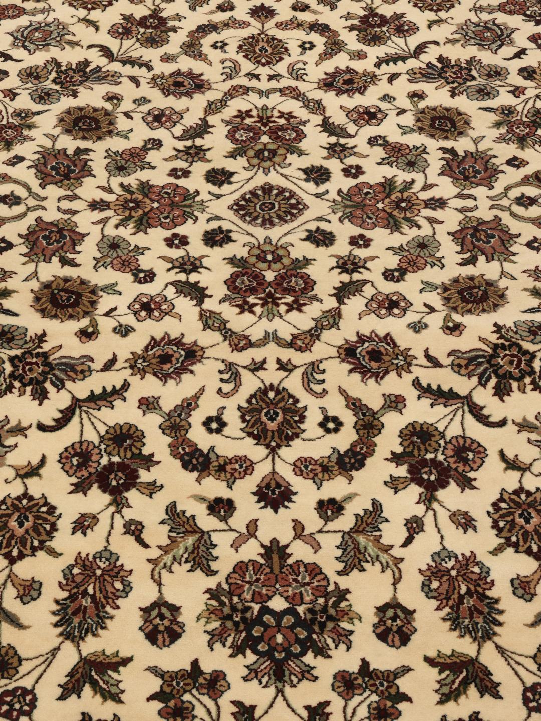 Tapis Sarough rond avec motif floral, noué à la main en Inde dans des tons beige.