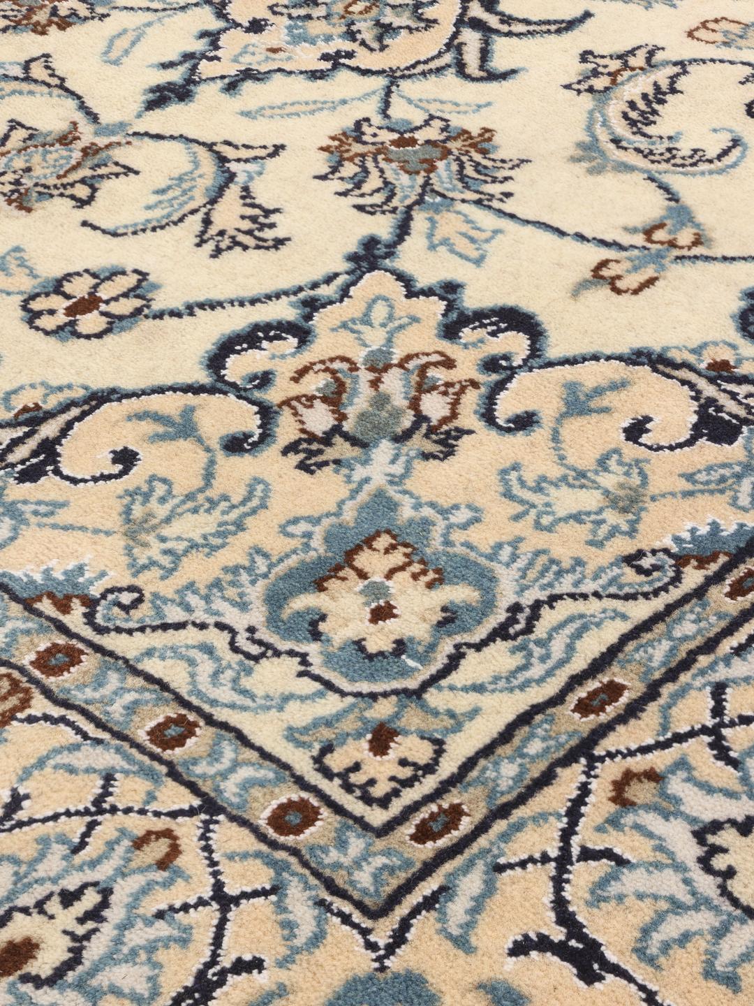 Hand-knotted Nain rug from the Middle East in beige with floral patterns