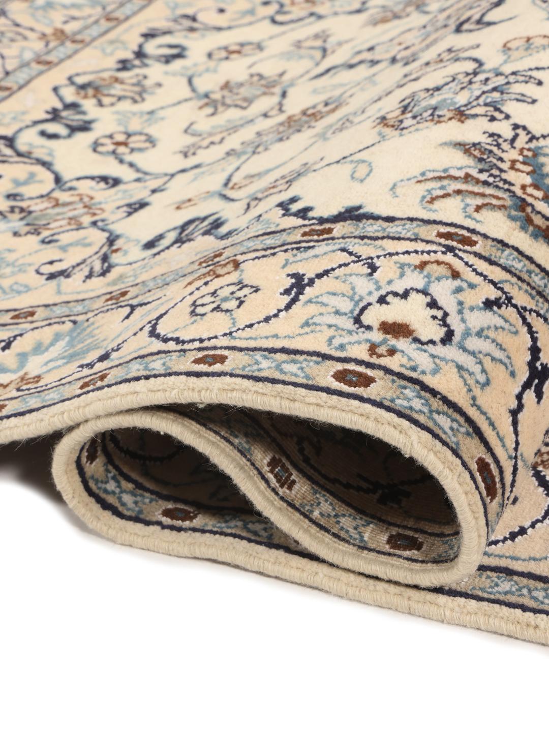 Hand-knotted Nain rug from the Middle East in beige with floral patterns