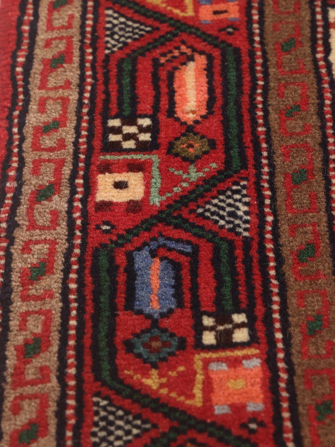 Hand-knotted red runner rug from the Middle East