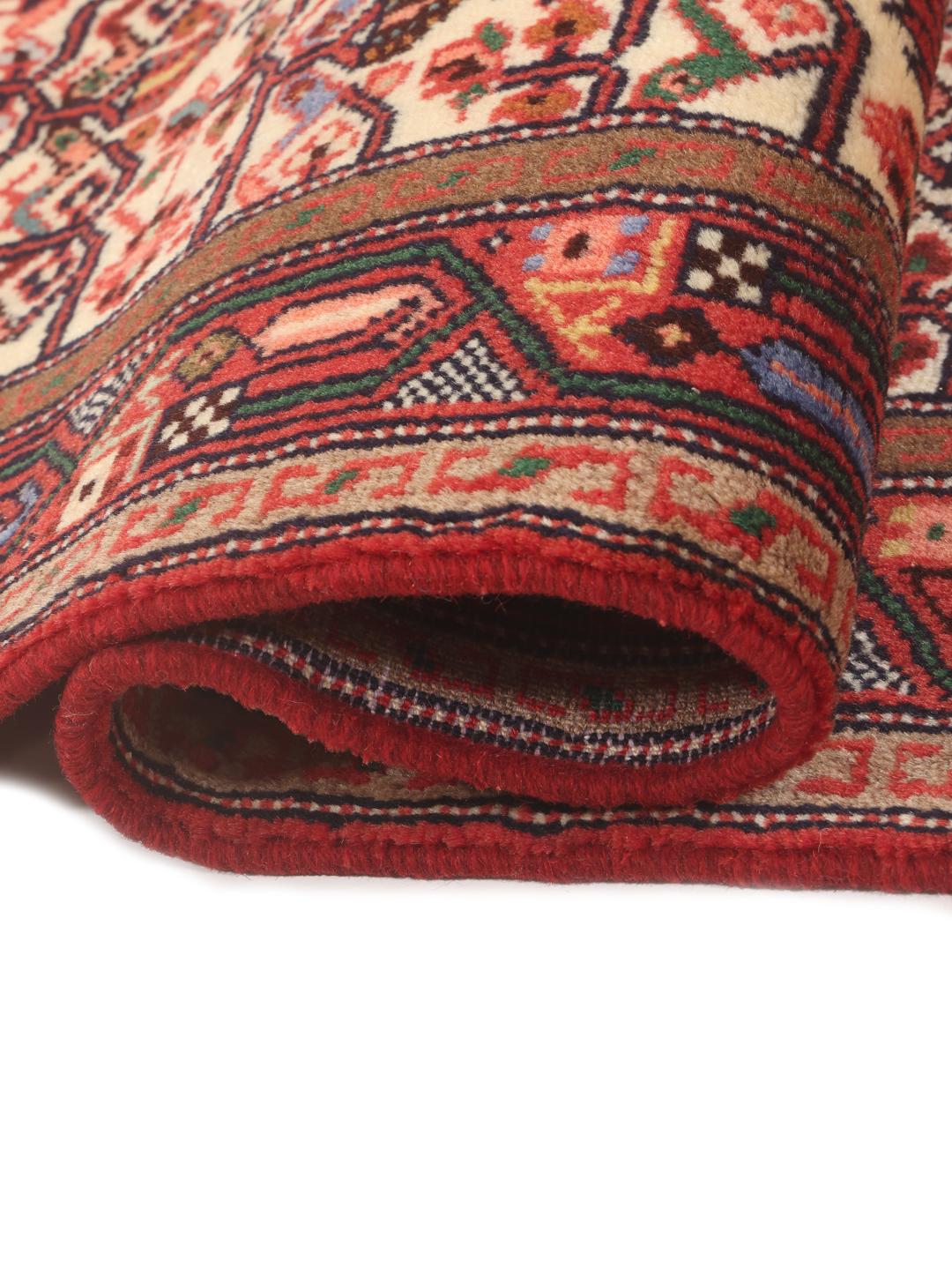 Hand-knotted red runner rug from the Middle East