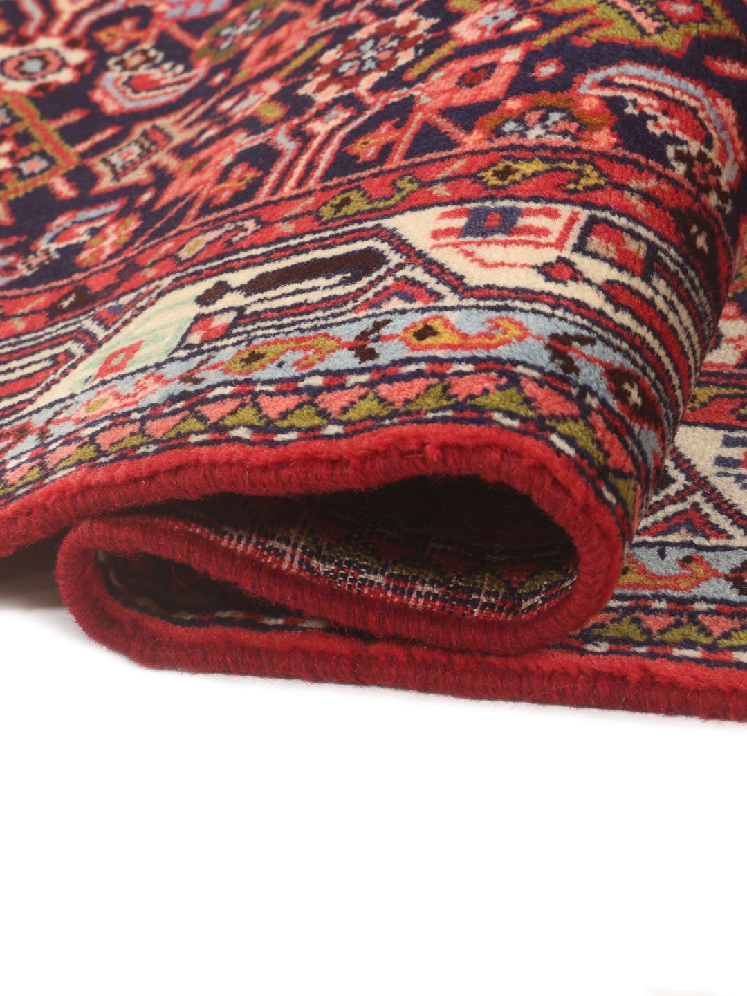 Hand-knotted Asadabad runner with intricate geometric patterns in dark red and blue tones