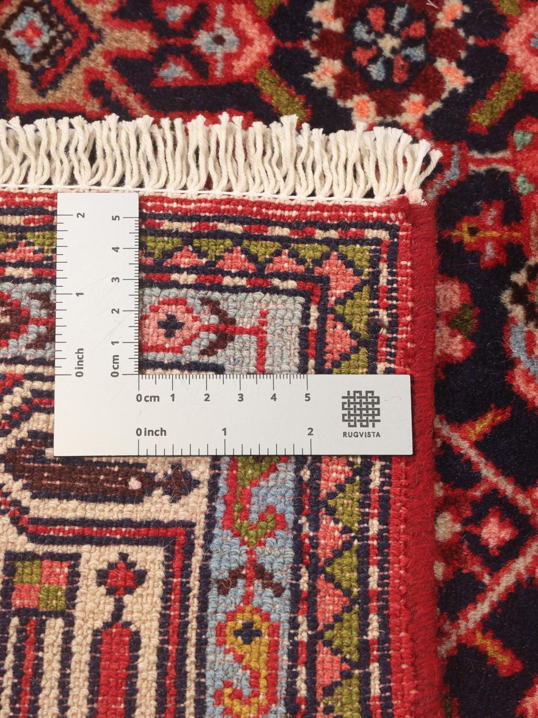 Hand-knotted Asadabad runner with intricate geometric patterns in dark red and blue tones