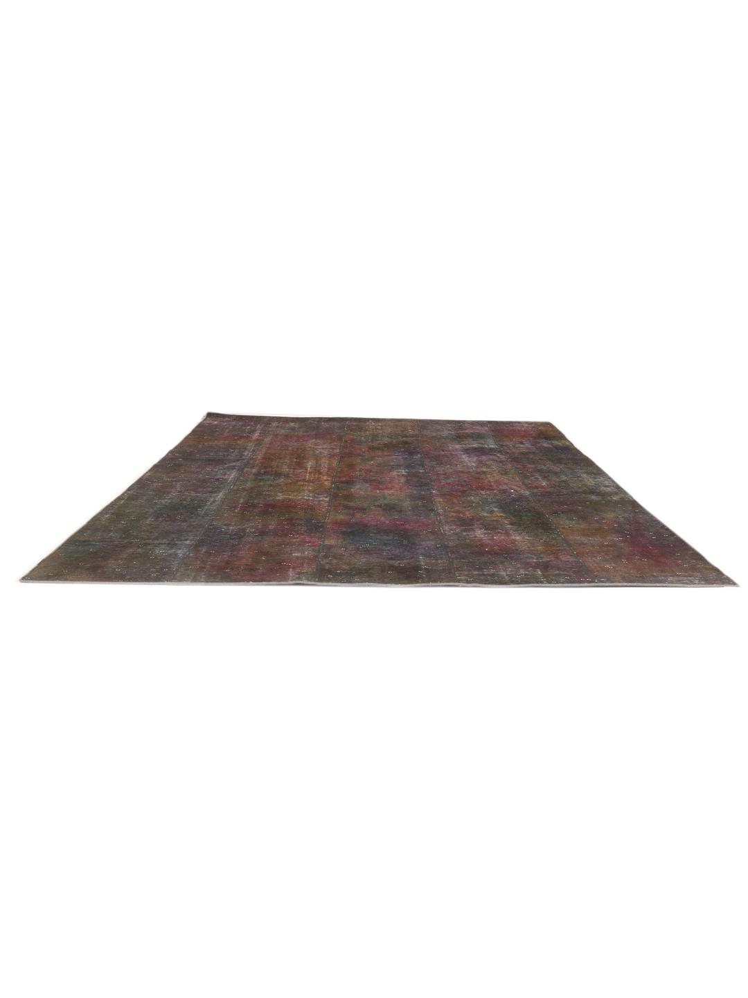 A unique, hand-knotted patchwork rug from the Middle East in dark-grey and dark-red tones.