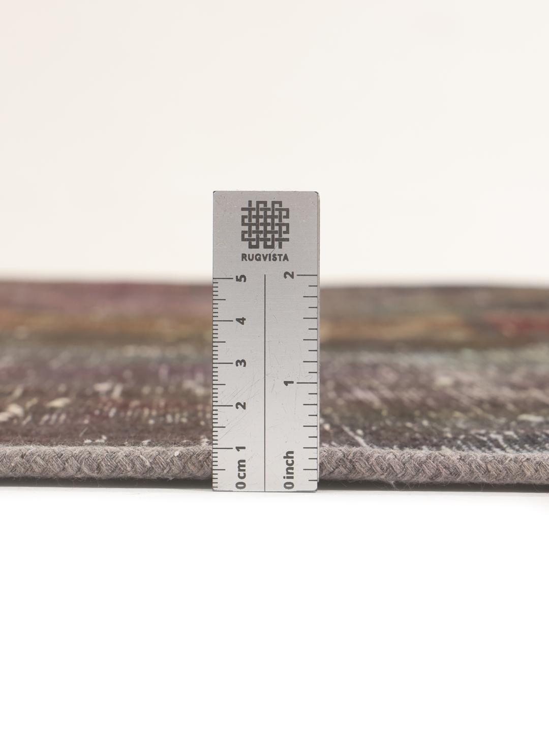 A unique, hand-knotted patchwork rug from the Middle East in dark-grey and dark-red tones.