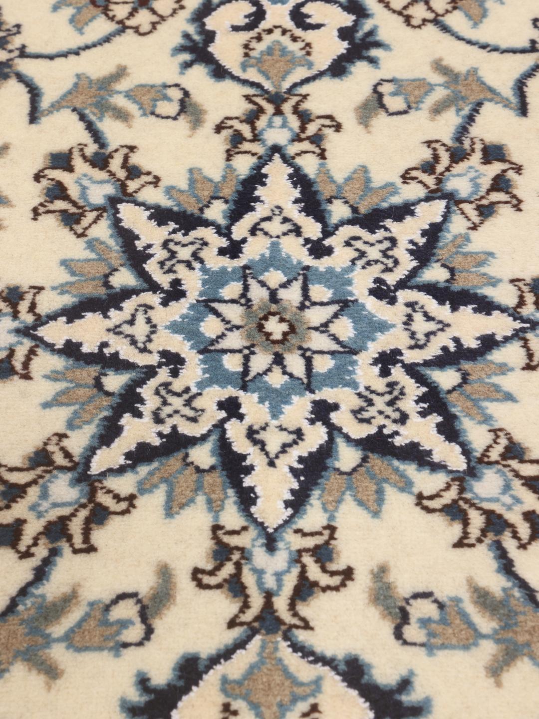 Hand-knotted Nain runner with floral motifs in beige and blue