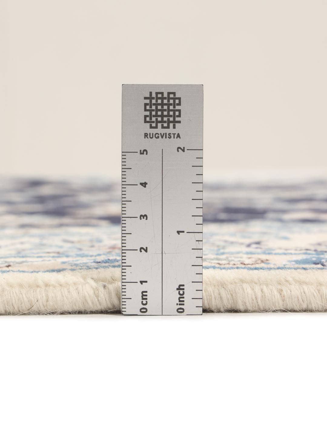 A hand-knotted Nain rug from the Middle East in dark-blue and cream tones.