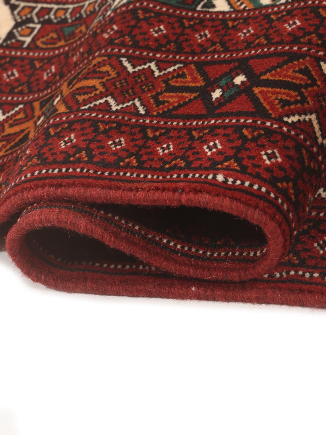 Hand-knotted Turkaman runner with traditional geometric patterns in rich red tones from the Middle East