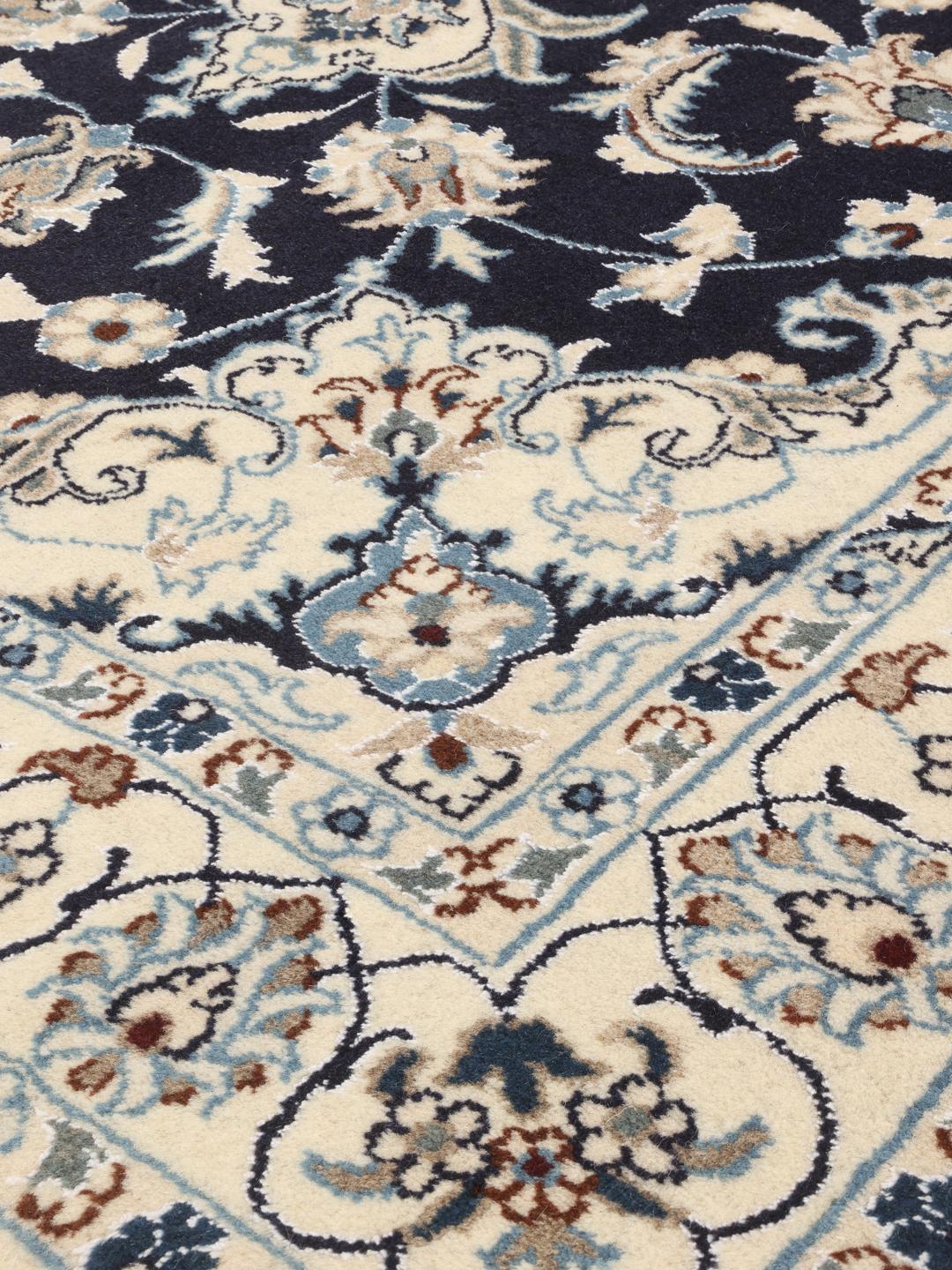 Authentic hand-knotted Nain rug with dark blue field and ivory floral patterns