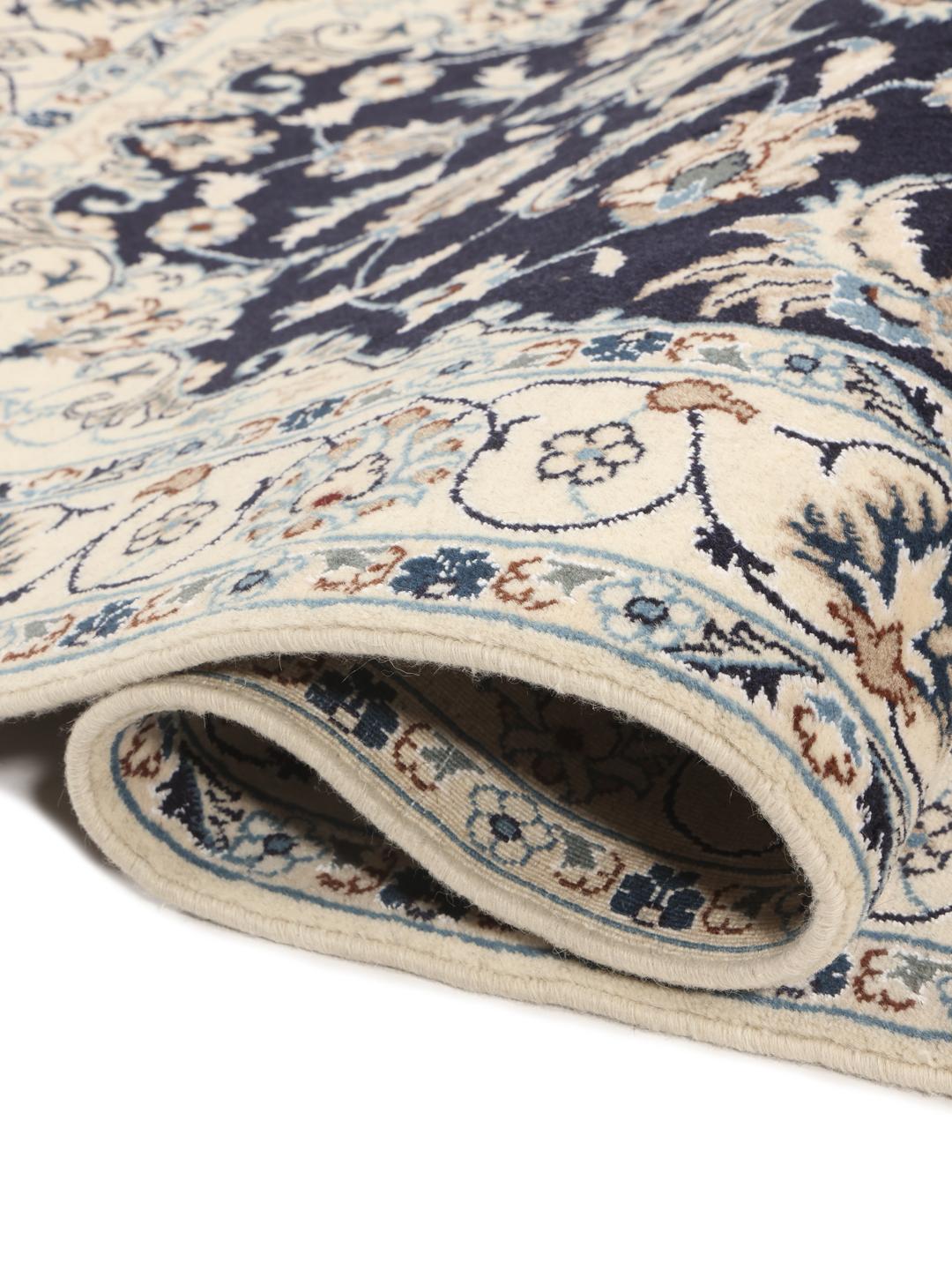Authentic hand-knotted Nain rug with dark blue field and ivory floral patterns