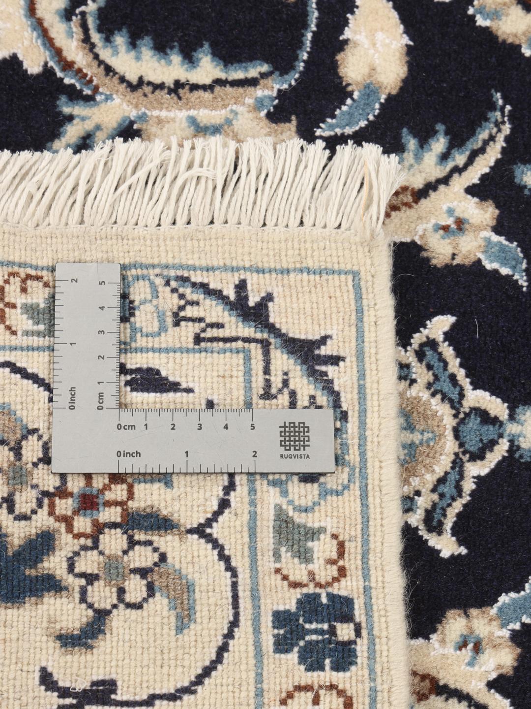 Authentic hand-knotted Nain rug with dark blue field and ivory floral patterns